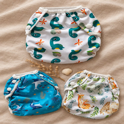 Wasbare zwemluier Dino design – collectie flat-lay